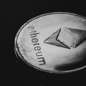 Close-up of an Ethereum coin on a dark background highlighting crypto finance concept.