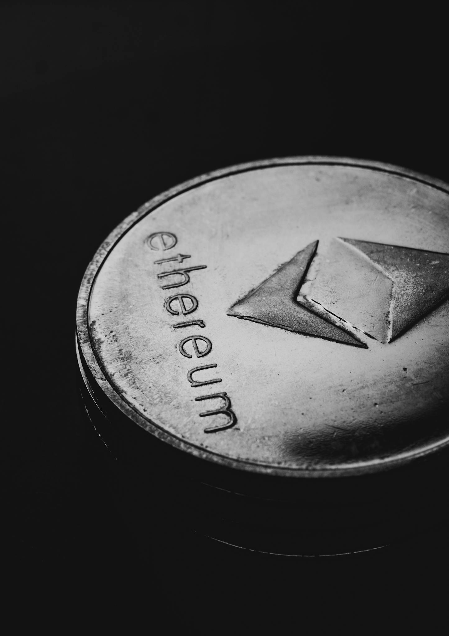 Close-up of an Ethereum coin on a dark background highlighting crypto finance concept.