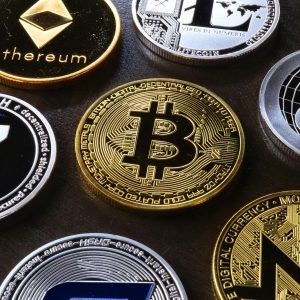 Detailed view of assorted cryptocurrency coins including Bitcoin, Ethereum, and Ripple.